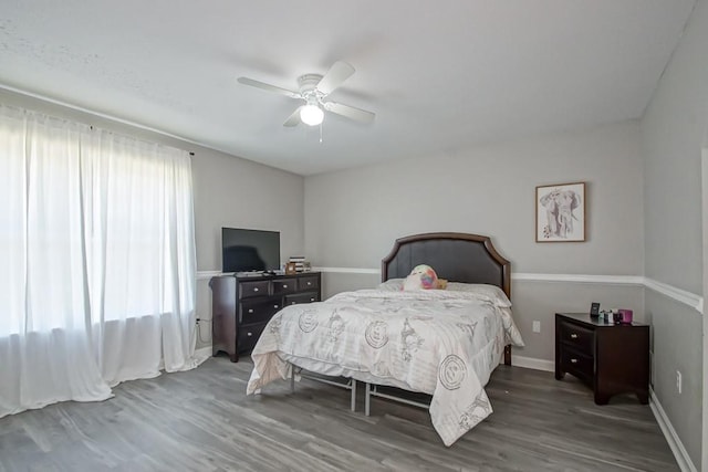 bedroom featuring dark hardwood / wood-style floors and ceiling fan