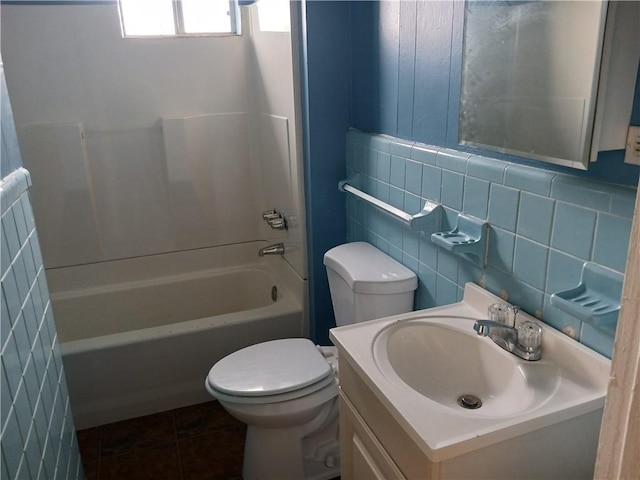 full bathroom featuring backsplash, tile patterned floors, washtub / shower combination, toilet, and tile walls