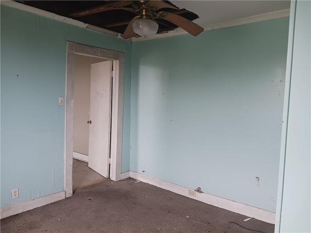 unfurnished room with ceiling fan and ornamental molding