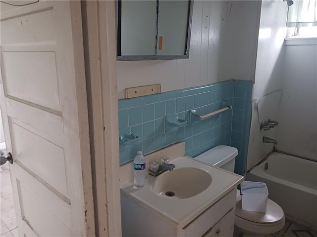 full bathroom featuring tile walls, vanity,  shower combination, and toilet