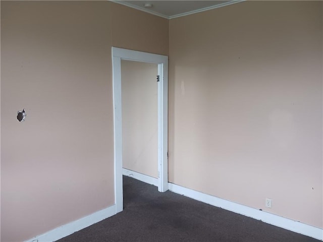 unfurnished room with dark colored carpet and crown molding