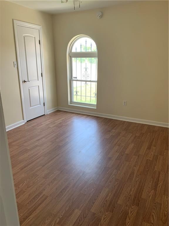 spare room featuring dark wood-type flooring