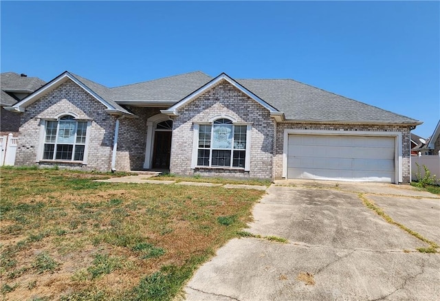 ranch-style house featuring a front lawn and a garage