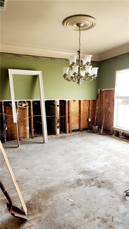 miscellaneous room with a notable chandelier and ornamental molding