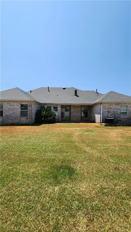 back of property featuring a yard