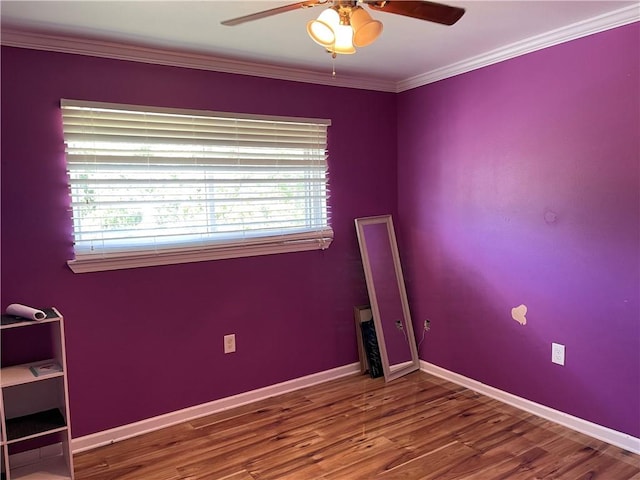 empty room with ceiling fan, crown molding, a wealth of natural light, and dark wood-type flooring