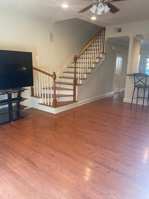 living room featuring ceiling fan, crown molding, and dark hardwood / wood-style floors