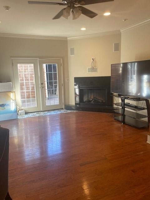 unfurnished living room with french doors, hardwood / wood-style floors, crown molding, and ceiling fan