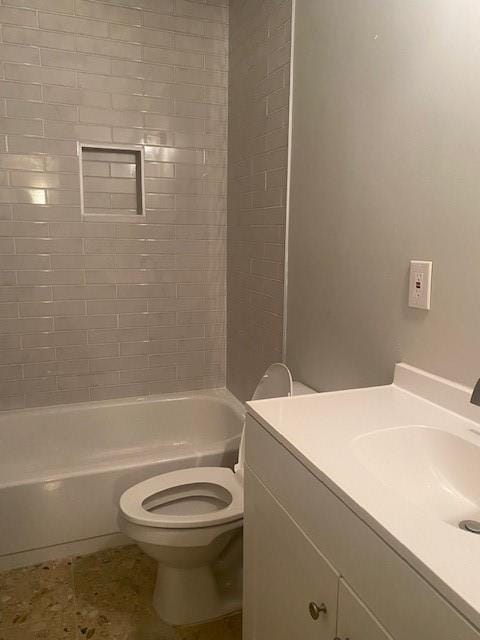 full bathroom featuring tile floors, toilet, vanity, and tiled shower / bath