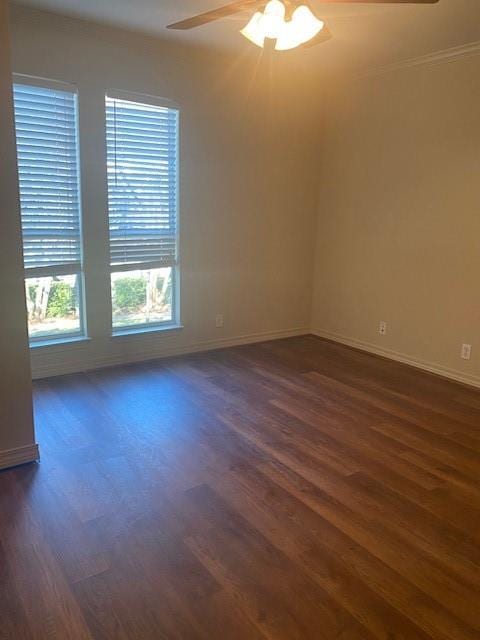 empty room with ceiling fan and dark hardwood / wood-style floors