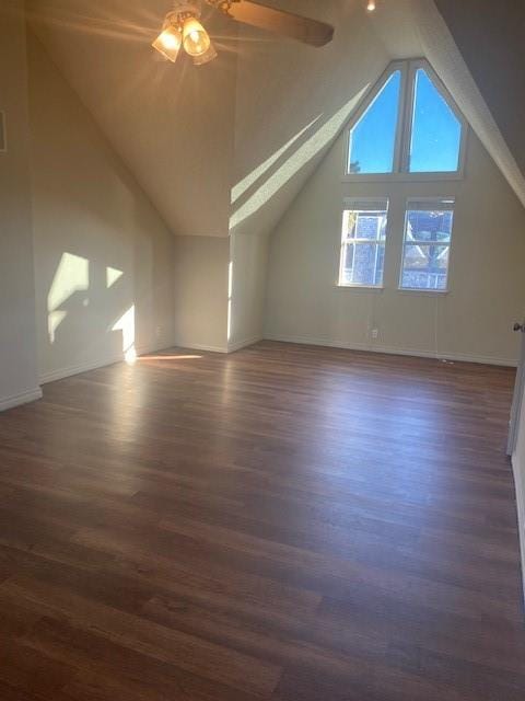 bonus room with dark wood-type flooring and vaulted ceiling