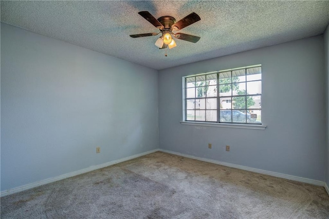 carpeted empty room with a textured ceiling and ceiling fan