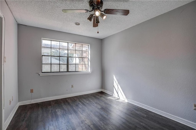 unfurnished room with ceiling fan, dark wood-type flooring, and a textured ceiling