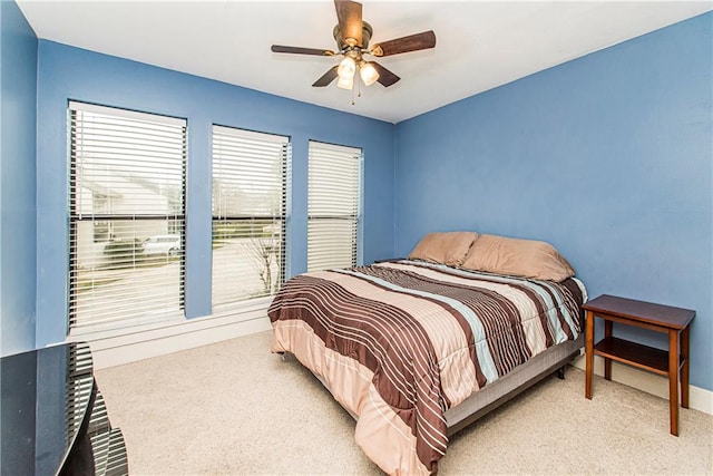 bedroom featuring light carpet and ceiling fan