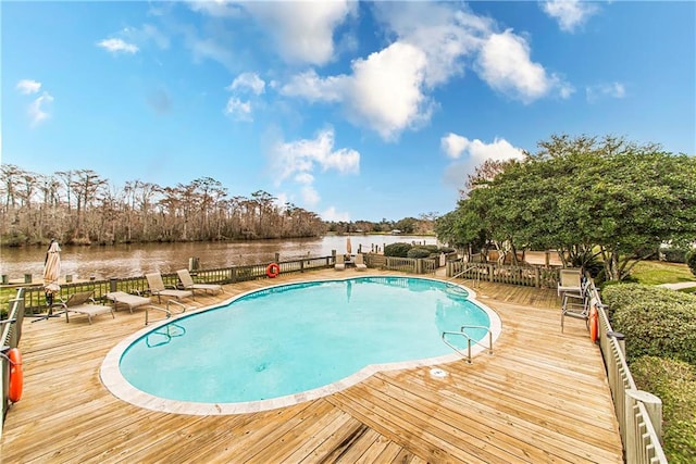 view of pool featuring a deck with water view