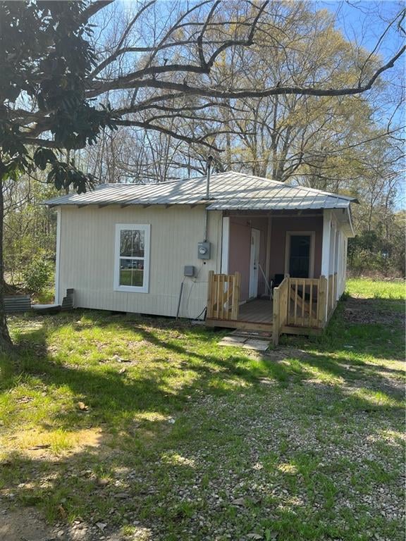 rear view of property with a yard