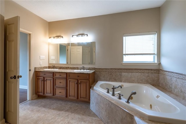 bathroom with double vanity, tile flooring, and a textured ceiling