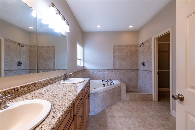 bathroom with oversized vanity, tile floors, double sink, and independent shower and bath