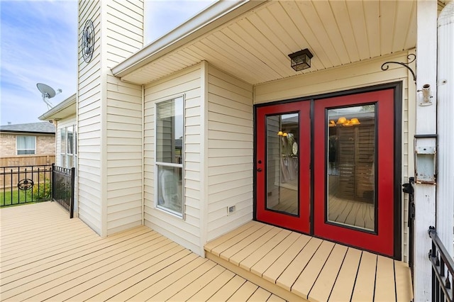 exterior space with a wooden deck and french doors