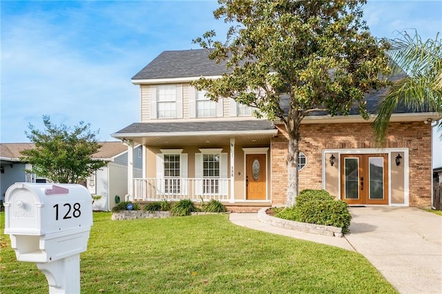 view of front of home featuring a porch, a front yard, and french doors