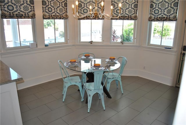 dining space featuring an inviting chandelier and tile floors