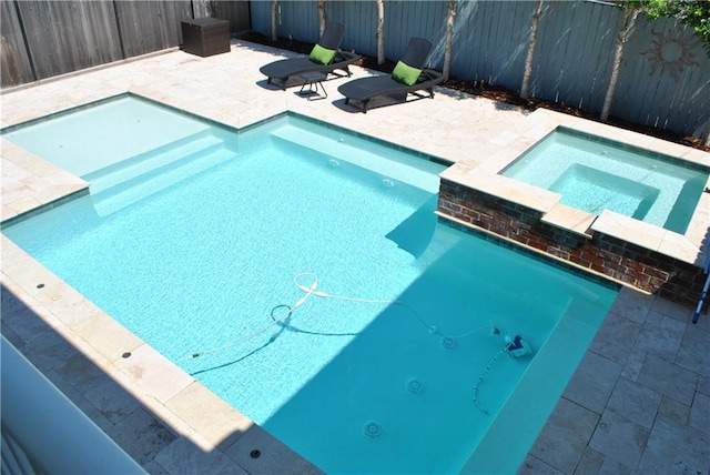 view of pool featuring a patio area and an in ground hot tub