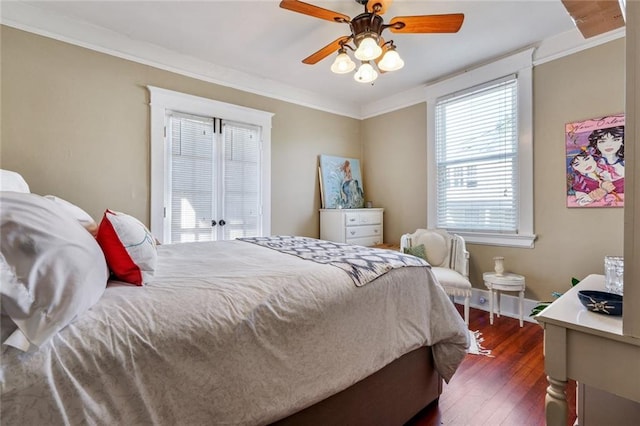 bedroom featuring ceiling fan, ornamental molding, dark hardwood / wood-style floors, and french doors