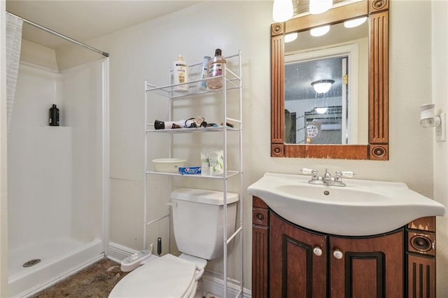 bathroom with vanity, toilet, and walk in shower