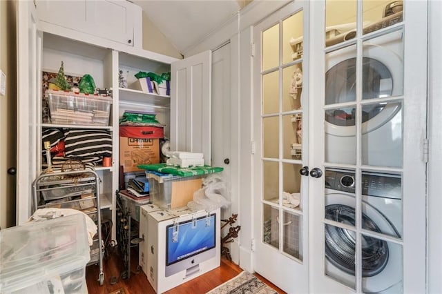 storage area with stacked washer and dryer