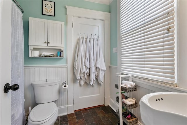 bathroom featuring tile floors and toilet