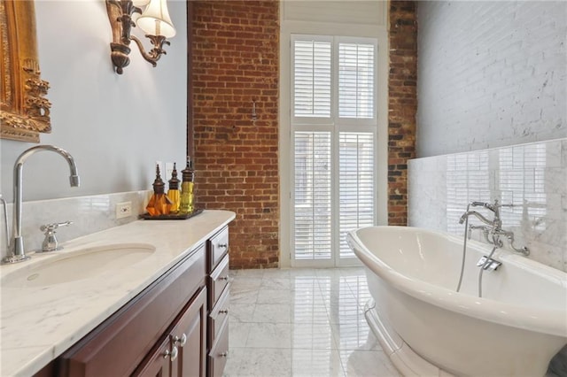 bathroom featuring brick wall, a bathing tub, vanity, and tile flooring