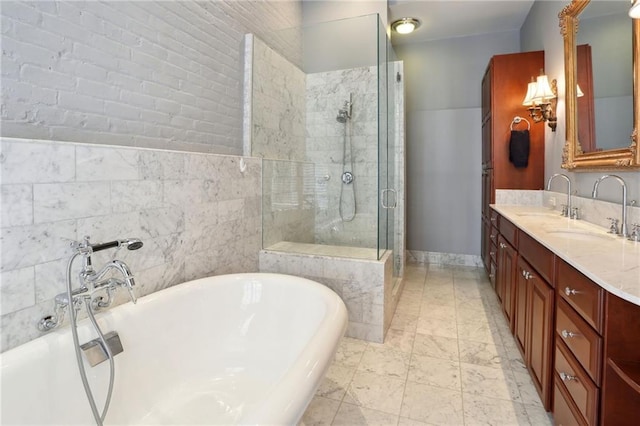 bathroom with tile flooring, large vanity, tile walls, and separate shower and tub