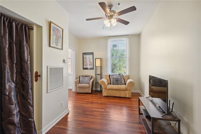 sitting room with ceiling fan and dark hardwood / wood-style flooring