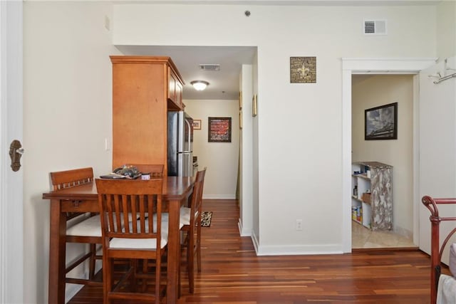 dining room featuring dark tile floors