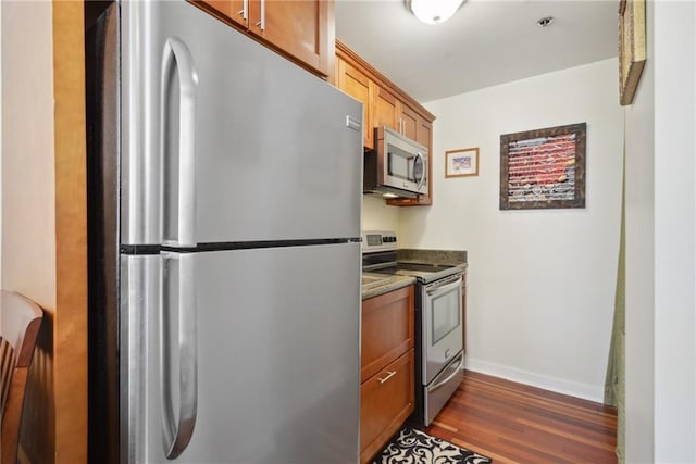 kitchen featuring dark hardwood / wood-style flooring and stainless steel appliances