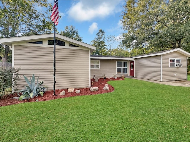 back of house featuring an outdoor structure and a yard