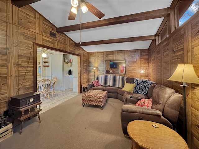 living room featuring light carpet, wooden walls, and ceiling fan