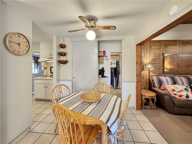 dining space featuring ceiling fan, light tile floors, and sink