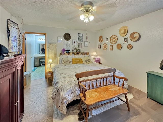 bedroom with ceiling fan, a textured ceiling, and light wood-type flooring