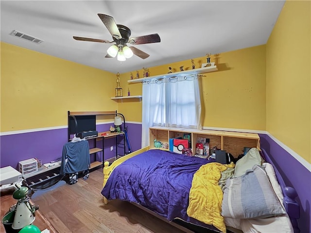 bedroom featuring hardwood / wood-style floors and ceiling fan