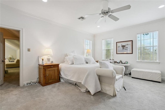 carpeted bedroom featuring ceiling fan and crown molding