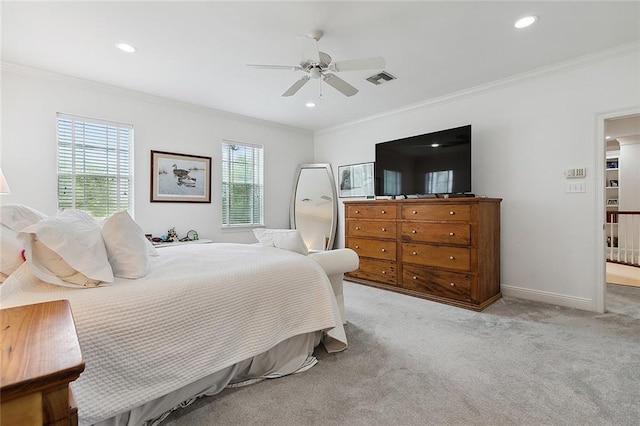 carpeted bedroom with ceiling fan, multiple windows, and ornamental molding