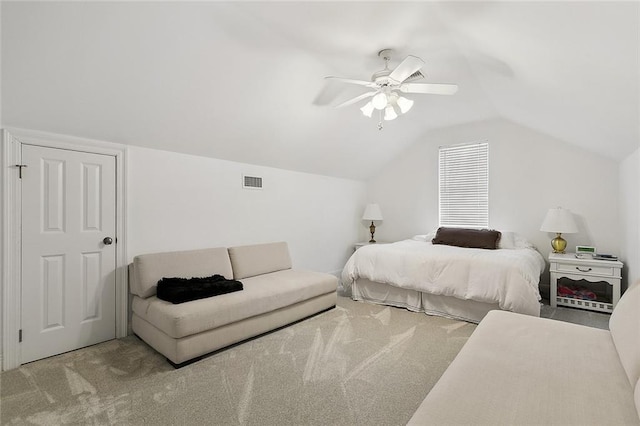 bedroom featuring light carpet, ceiling fan, and vaulted ceiling