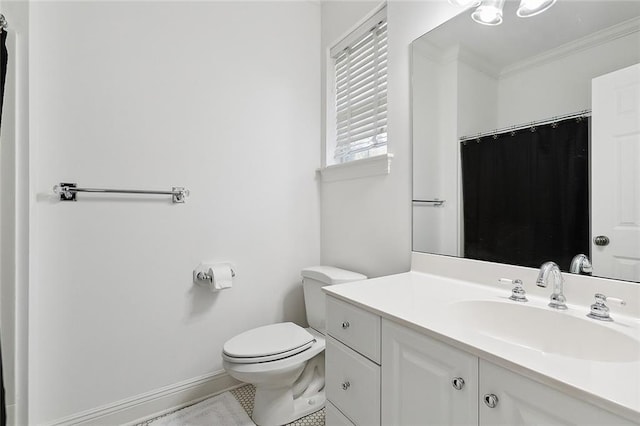 bathroom featuring crown molding, toilet, tile floors, and vanity with extensive cabinet space