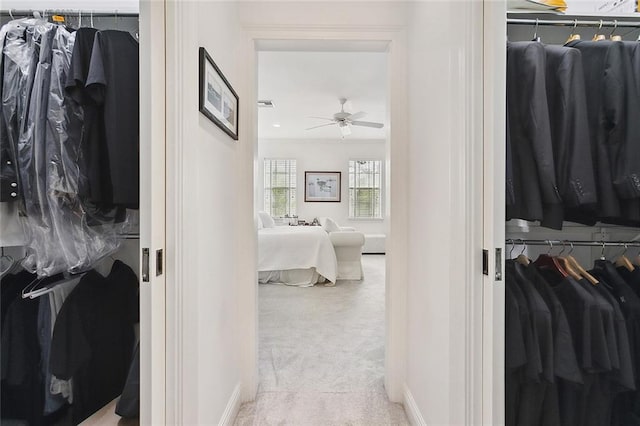 interior space featuring ceiling fan and light carpet