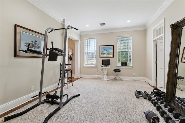 workout area featuring crown molding