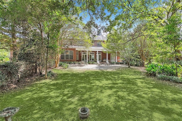 rear view of house with a lawn