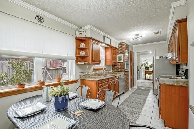 kitchen with visible vents, range with electric cooktop, brown cabinets, stainless steel dishwasher, and a sink