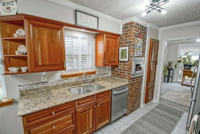 kitchen with light stone counters, ornamental molding, stainless steel appliances, a textured ceiling, and a sink