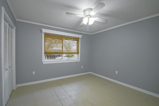 unfurnished bedroom with baseboards, ornamental molding, and a textured ceiling